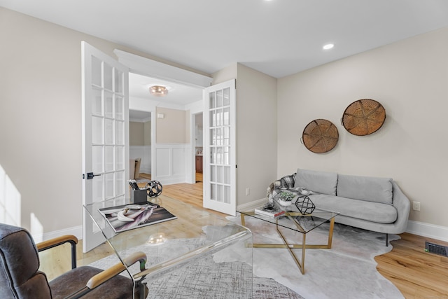 living room with french doors and hardwood / wood-style flooring