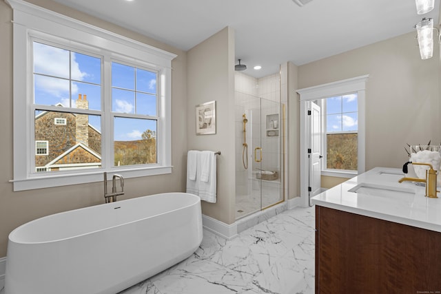 167 Willow Creek Estates Dr, Southbury, CT 06488 - full bathroom featuring a shower stall, marble look tile flooring, a freestanding tub, double vanity, and baseboards
