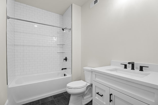 full bathroom featuring tiled shower / bath, vanity, toilet, and tile patterned flooring