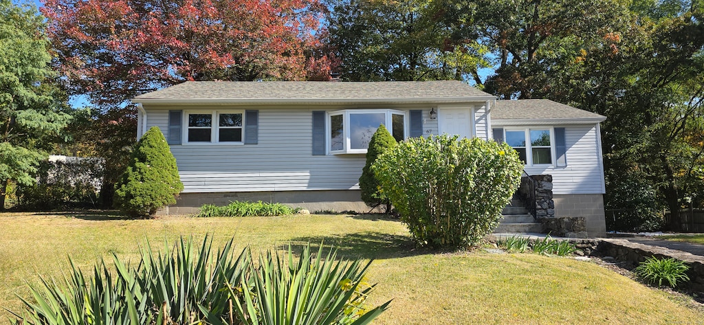 bungalow-style home featuring a front yard