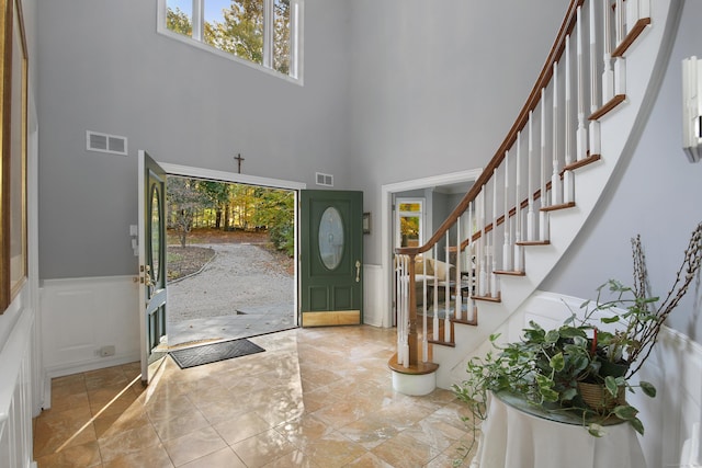 foyer entrance featuring tile patterned floors and a high ceiling