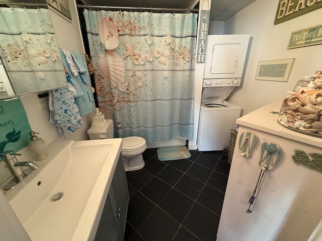 bathroom with tile patterned floors, toilet, a shower with curtain, vanity, and stacked washer / dryer