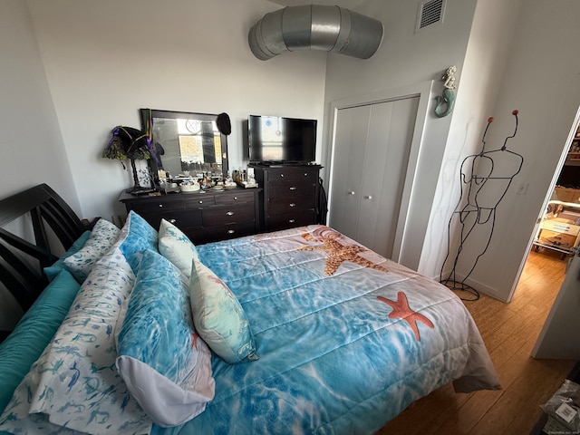 bedroom featuring a closet and light hardwood / wood-style flooring