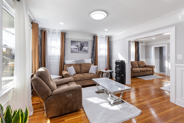 living room featuring crown molding and light wood-type flooring