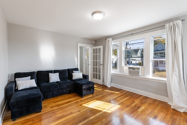 living room featuring a wealth of natural light, hardwood / wood-style floors, and cooling unit