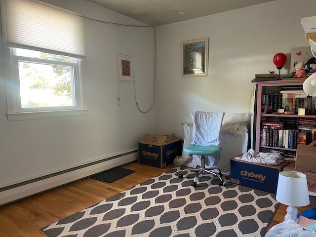 living area featuring hardwood / wood-style floors and a baseboard radiator