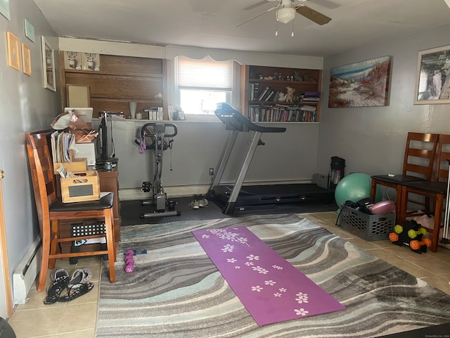 exercise area with a baseboard radiator, ceiling fan, and tile patterned flooring