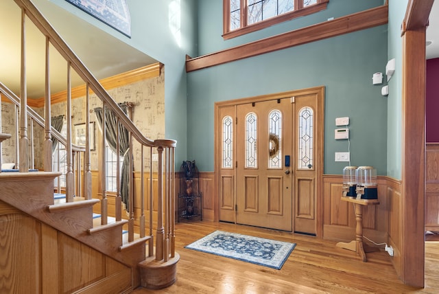 18 Eastern Ln, New Milford, CT 06776 - entryway with a towering ceiling, wainscoting, wood finished floors, and stairs