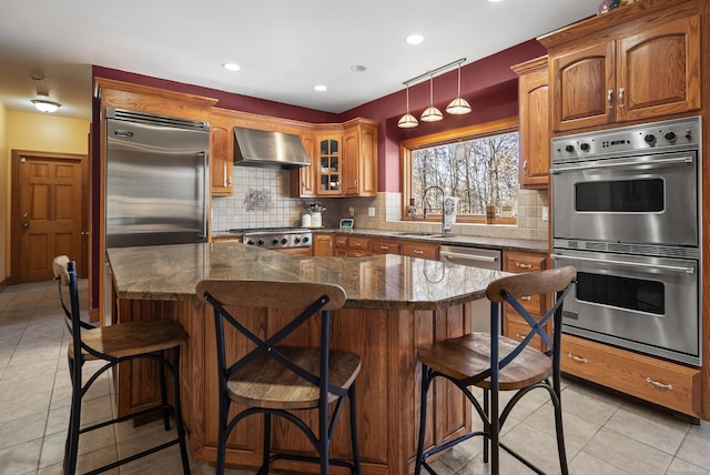 18 Eastern Ln, New Milford, CT 06776 - kitchen featuring stainless steel appliances, wall chimney range hood, light tile patterned floors, tasteful backsplash, and dark stone counters