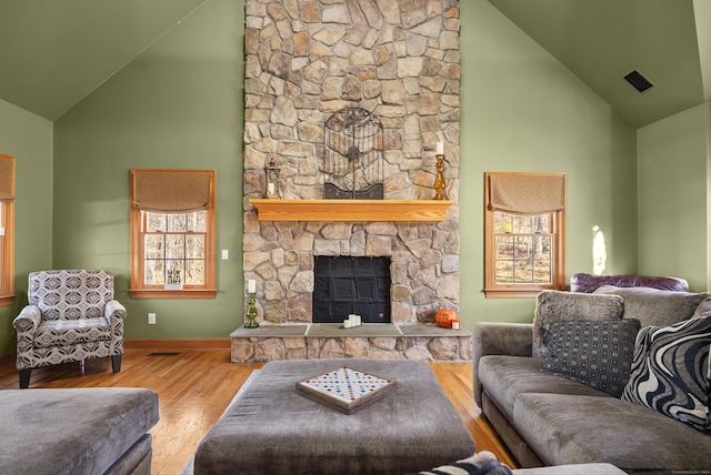 18 Eastern Ln, New Milford, CT 06776 - living room featuring high vaulted ceiling, wood finished floors, and a stone fireplace