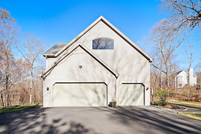 18 Eastern Ln, New Milford, CT 06776 - view of home's exterior featuring asphalt driveway and an attached garage