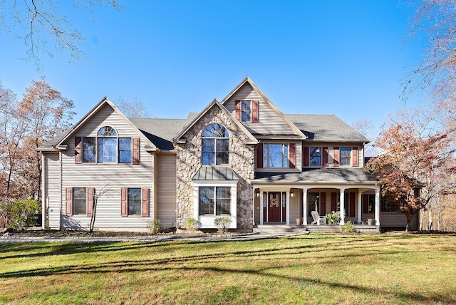 view of front of property with a front yard and covered porch