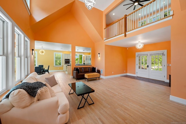 living room with plenty of natural light, baseboards, and wood finished floors