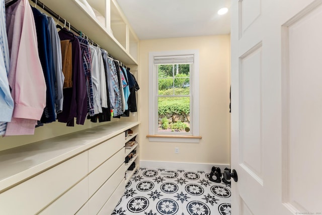 walk in closet with light tile patterned flooring