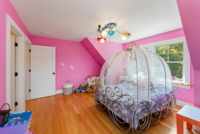 bedroom with wood finished floors and baseboards