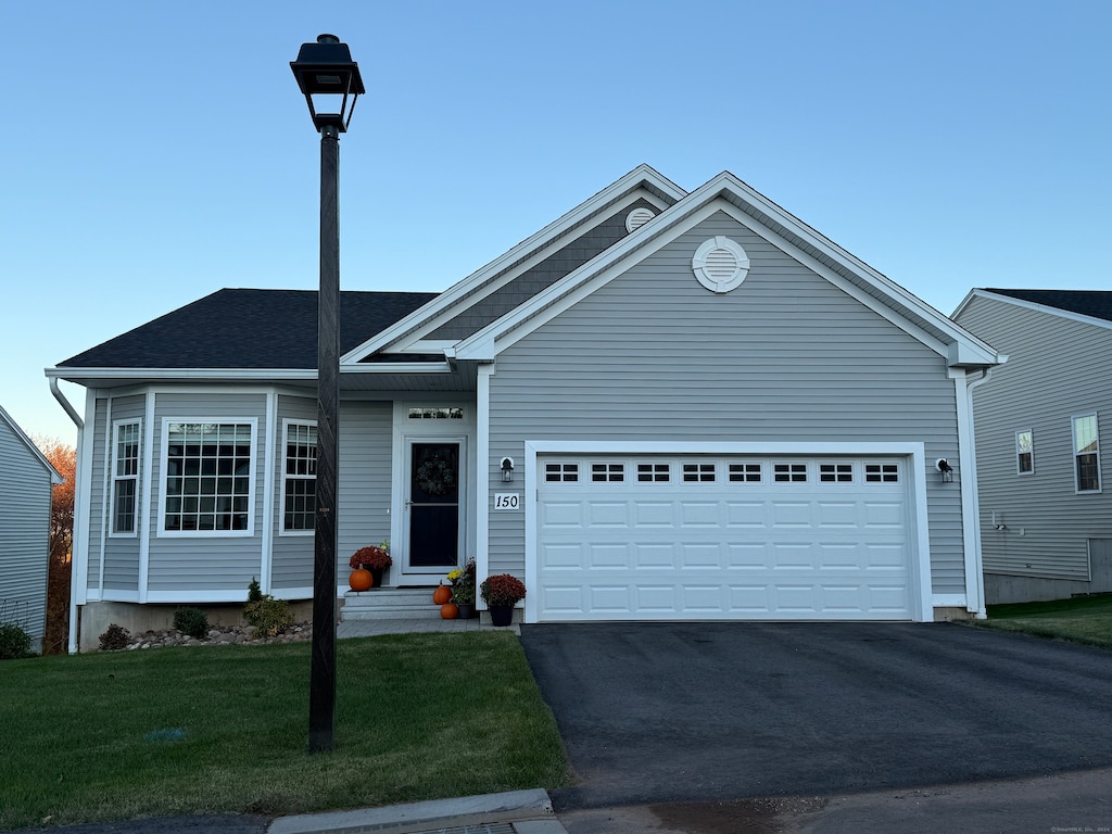 view of front of house with a front yard and a garage