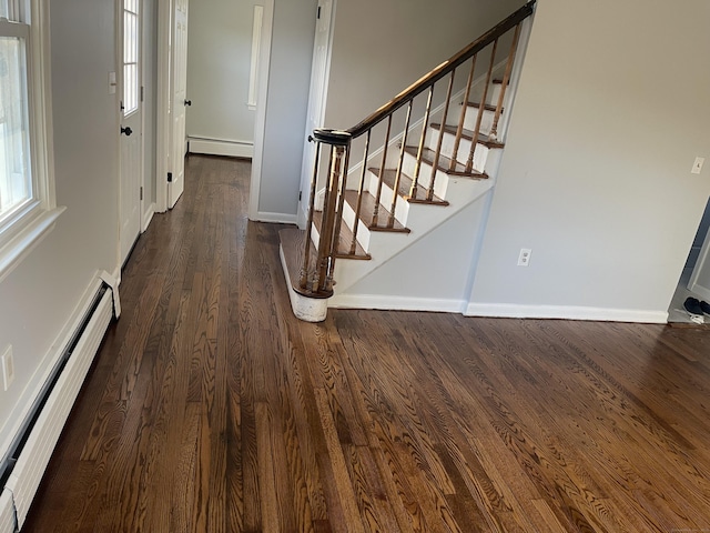 entryway with dark hardwood / wood-style floors and baseboard heating