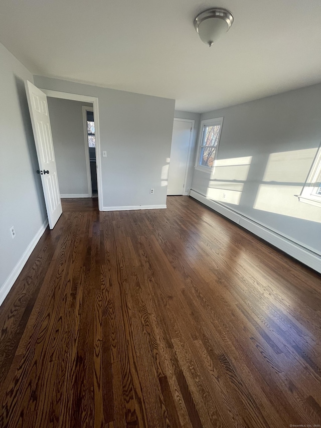 interior space featuring dark hardwood / wood-style floors and baseboard heating