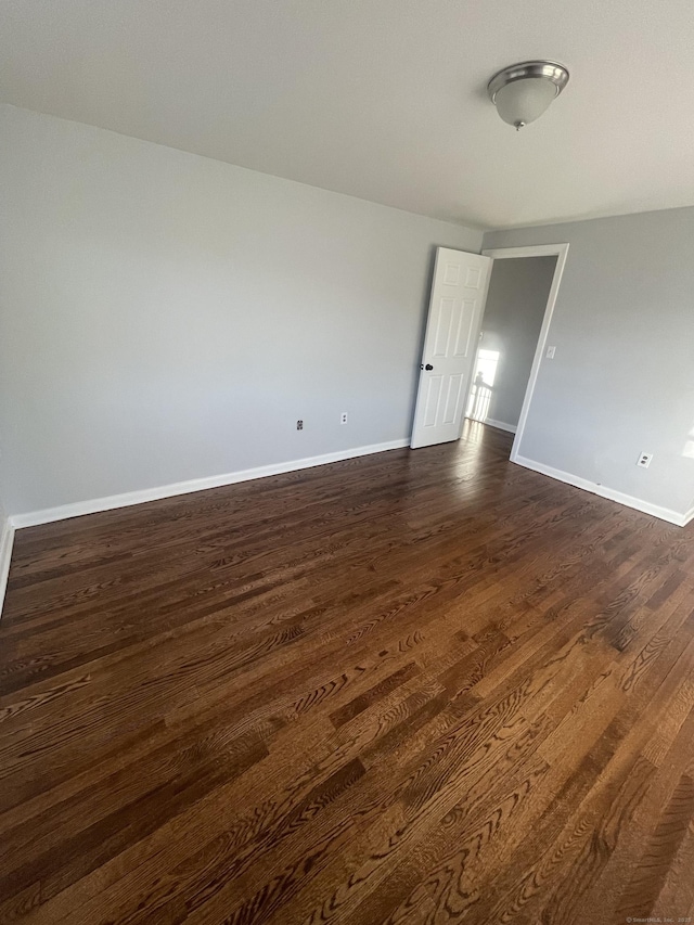 unfurnished room featuring dark hardwood / wood-style flooring