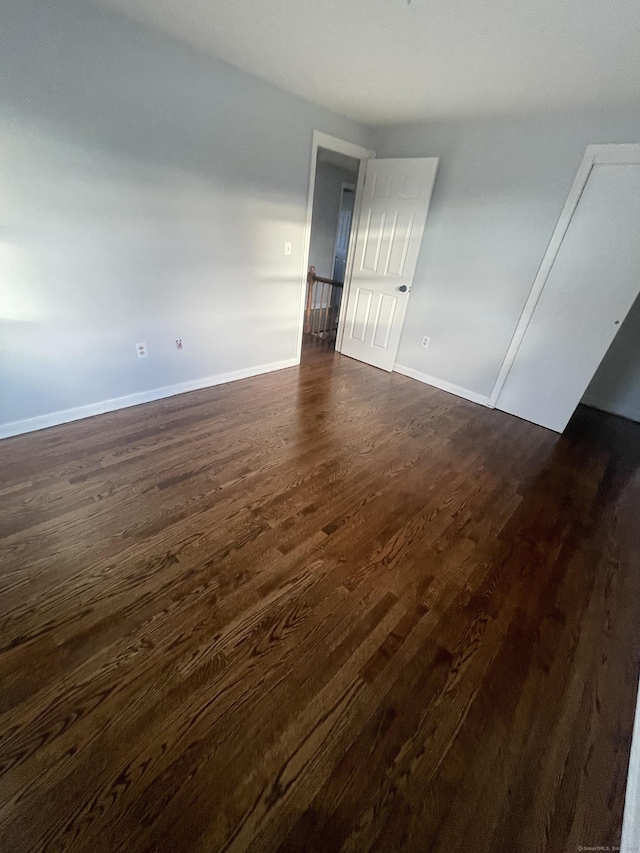 unfurnished room featuring dark hardwood / wood-style floors