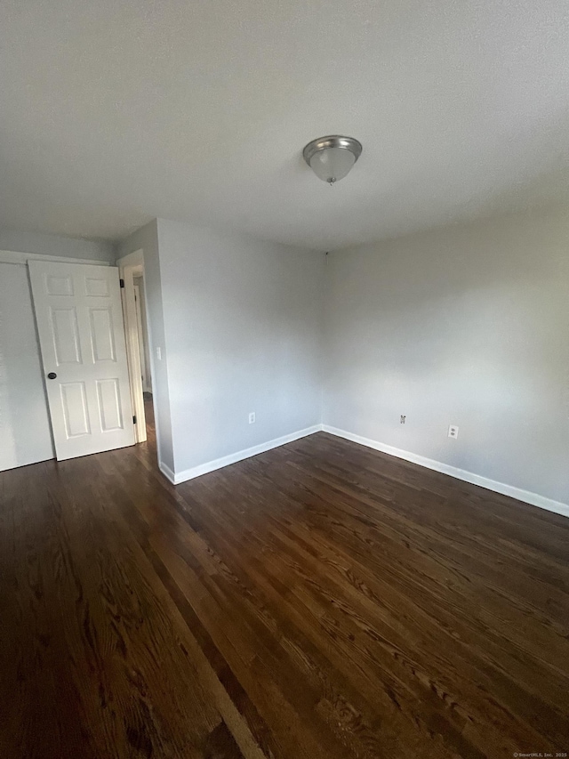 spare room featuring dark hardwood / wood-style flooring