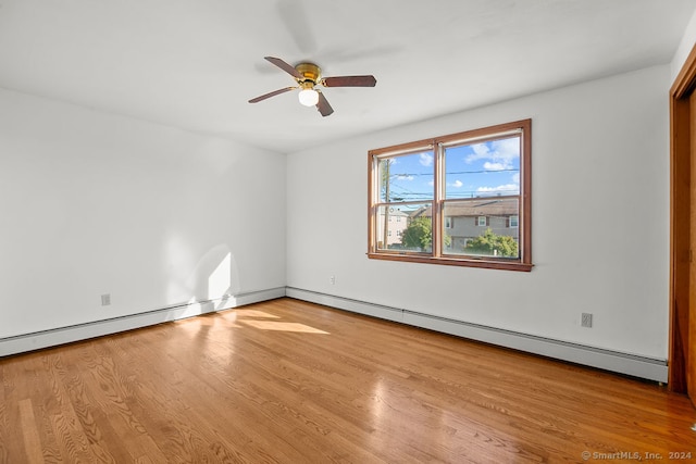 unfurnished room featuring ceiling fan, a baseboard heating unit, and light wood-type flooring