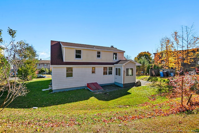 back of property featuring a yard