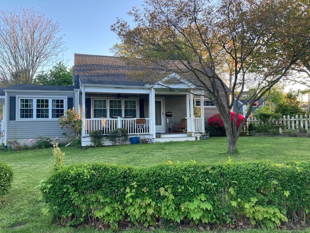 view of front of property with covered porch and a front yard