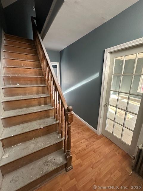 stairway featuring hardwood / wood-style flooring