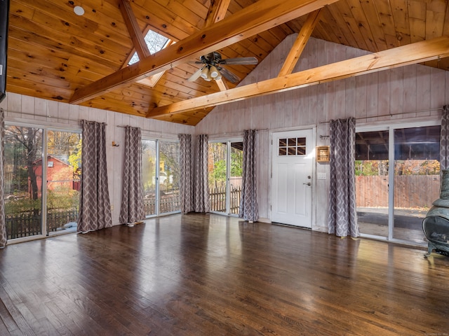 interior space featuring beamed ceiling, wood ceiling, and a skylight