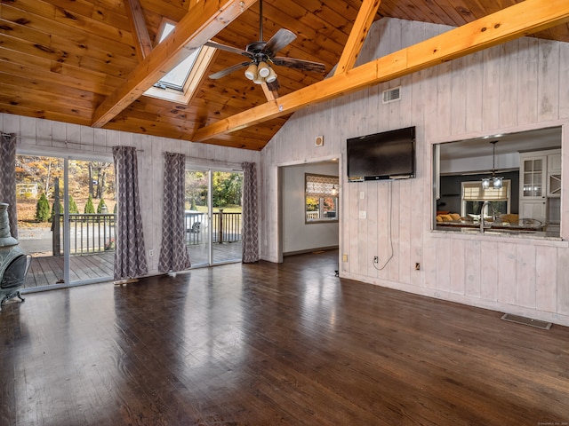 unfurnished living room with beamed ceiling, dark hardwood / wood-style floors, high vaulted ceiling, and a skylight