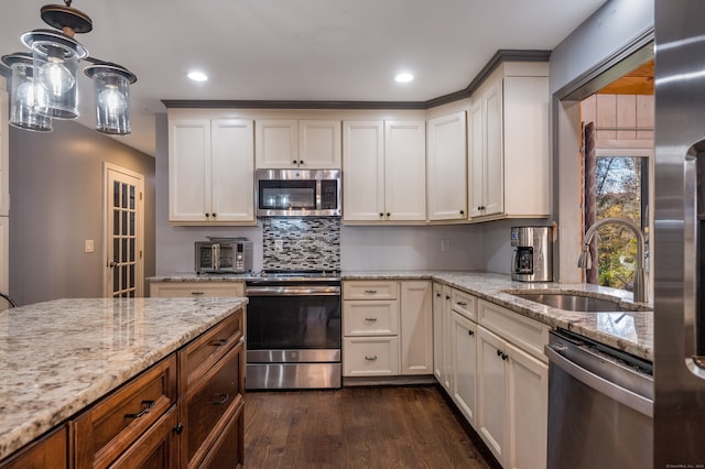 kitchen featuring dark hardwood / wood-style floors, stainless steel appliances, sink, light stone countertops, and white cabinets