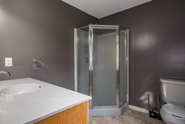 bathroom with vanity, tile patterned floors, toilet, and an enclosed shower