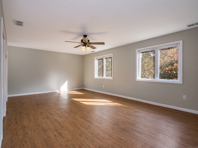 spare room featuring ceiling fan and dark hardwood / wood-style floors