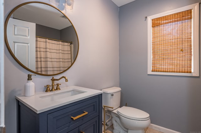 bathroom with toilet and vanity