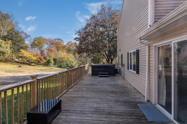 wooden terrace featuring a hot tub