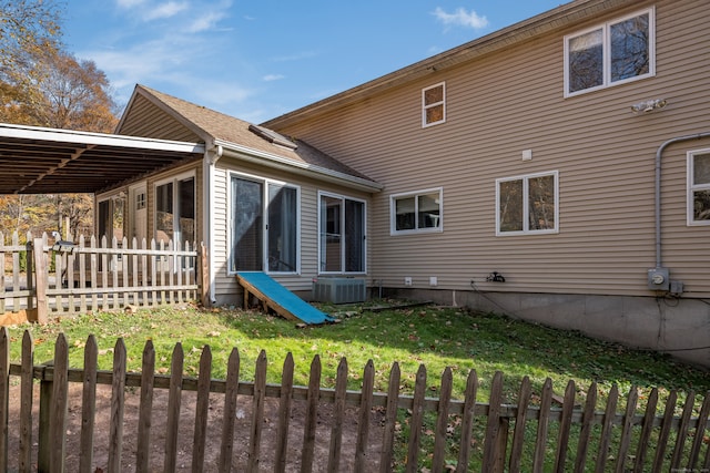 rear view of house featuring cooling unit