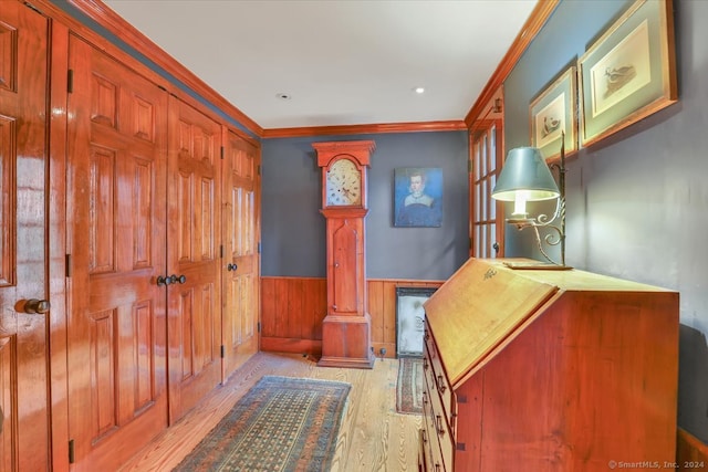 bedroom featuring ornamental molding, decorative columns, light hardwood / wood-style flooring, and a closet