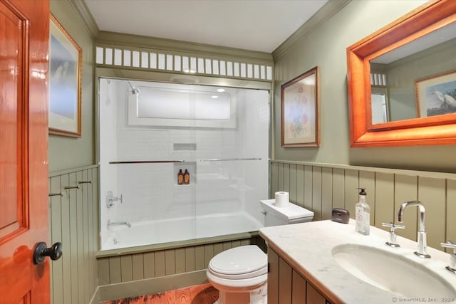 full bathroom with toilet, tiled shower / bath combo, vanity, and ornamental molding