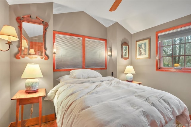 bedroom featuring lofted ceiling, hardwood / wood-style flooring, and ceiling fan