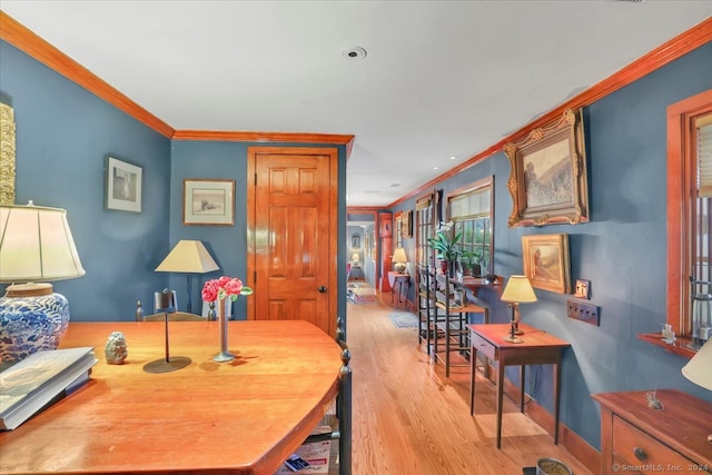 dining room with crown molding and light hardwood / wood-style flooring