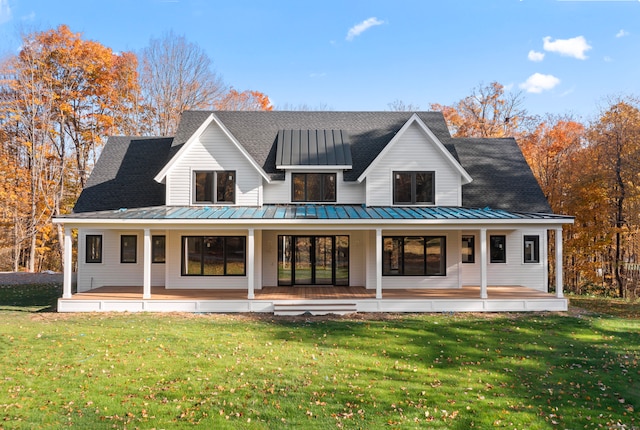 back of property featuring a yard and a porch