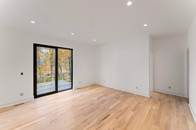 empty room with light hardwood / wood-style flooring