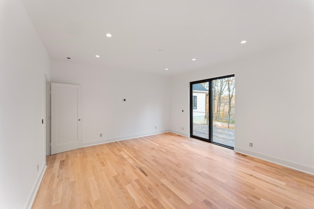 spare room with light hardwood / wood-style flooring