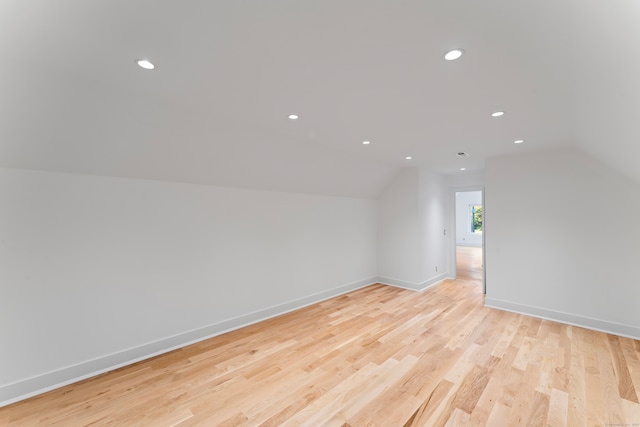 bonus room featuring light hardwood / wood-style floors and vaulted ceiling