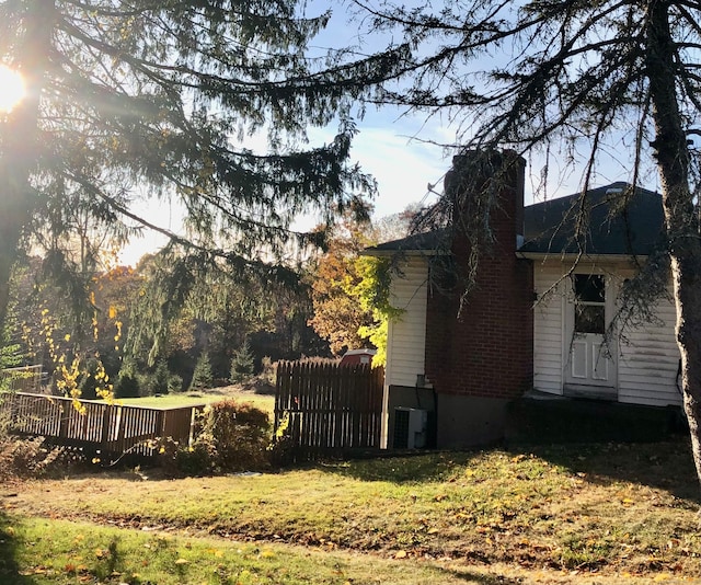 view of home's exterior featuring central air condition unit and a yard