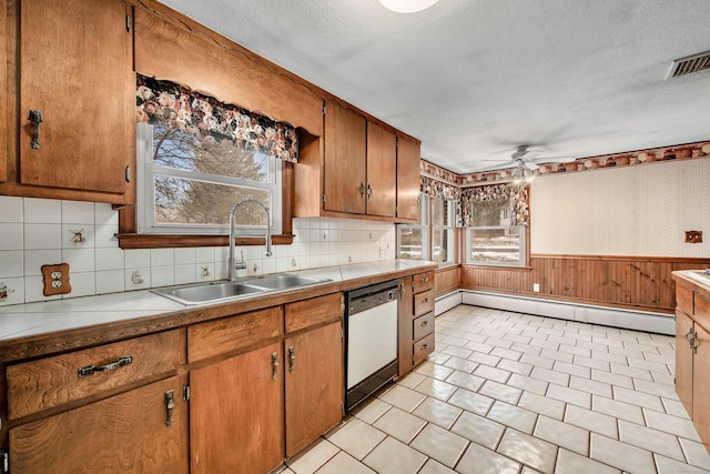 kitchen featuring sink, ceiling fan, white dishwasher, a textured ceiling, and a baseboard radiator