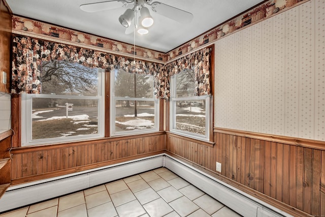 unfurnished sunroom with ceiling fan