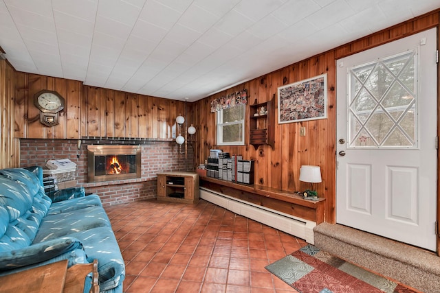 living room featuring a baseboard heating unit, wooden walls, tile patterned floors, and a fireplace