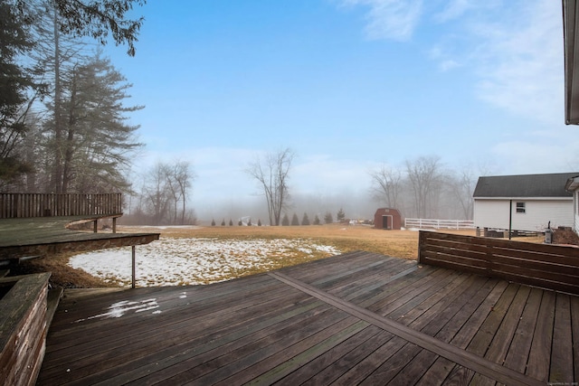 wooden terrace with a storage shed